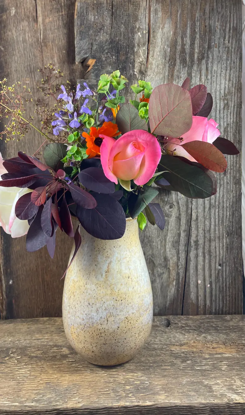 Rustic cream vase with fresh flowers